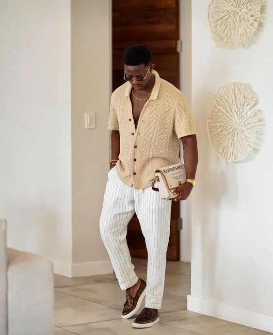 Outfit: Beige knitted polo shirt, White pinstripe trousers, Brown tassel loafers, Burberry shoulder bag