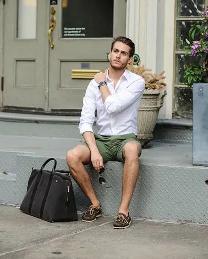 Outfit: White long-sleeve button-down shirt, Olive green chino shorts, Brown leather boat shoes, Silver-tone watch with dark strap