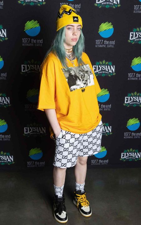 Outfit: Yellow beanie, Yellow graphic t-shirt, White logo shorts, Black and white high-top sneakers