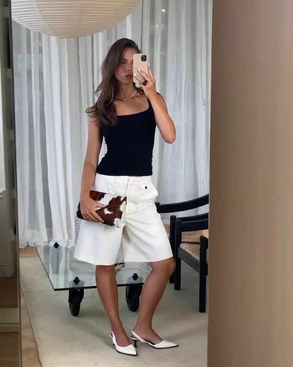 Outfit: Black square neck tank top, White Bermuda shorts, Cow print clutch bag, White kitten heel slingback shoes