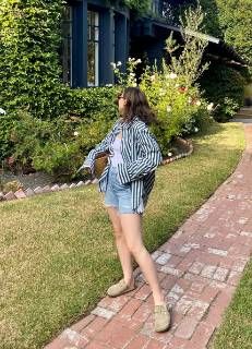 Outfit: Green and white striped button-up shirt, White tank top, Light wash denim shorts, Tan suede clogs