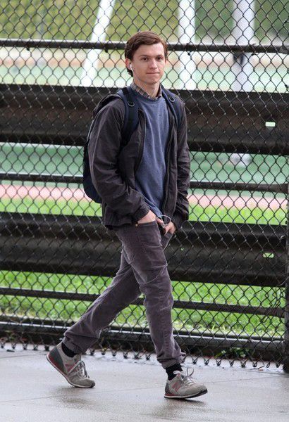 Outfit: Dark grey bomber jacket, Blue crew neck sweater, Plaid button-up shirt, Charcoal slim-fit jeans